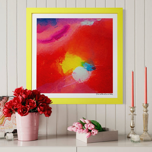 Colorful abstract painting in a yellow frame on a wall with decorative items below.